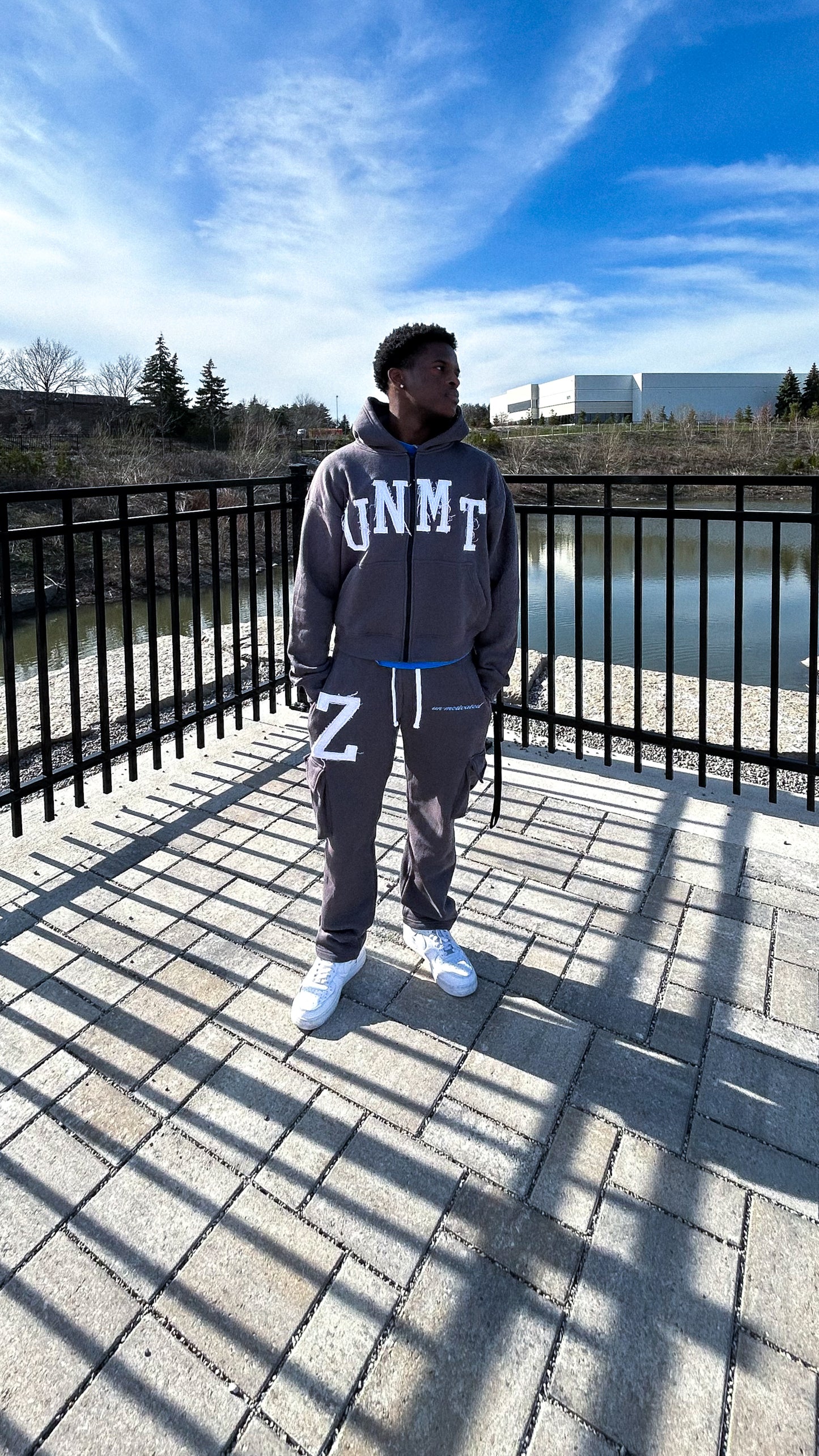 Model is wearing our “VICTORY” cargo pants and hoodie in the charcoal grey colorway