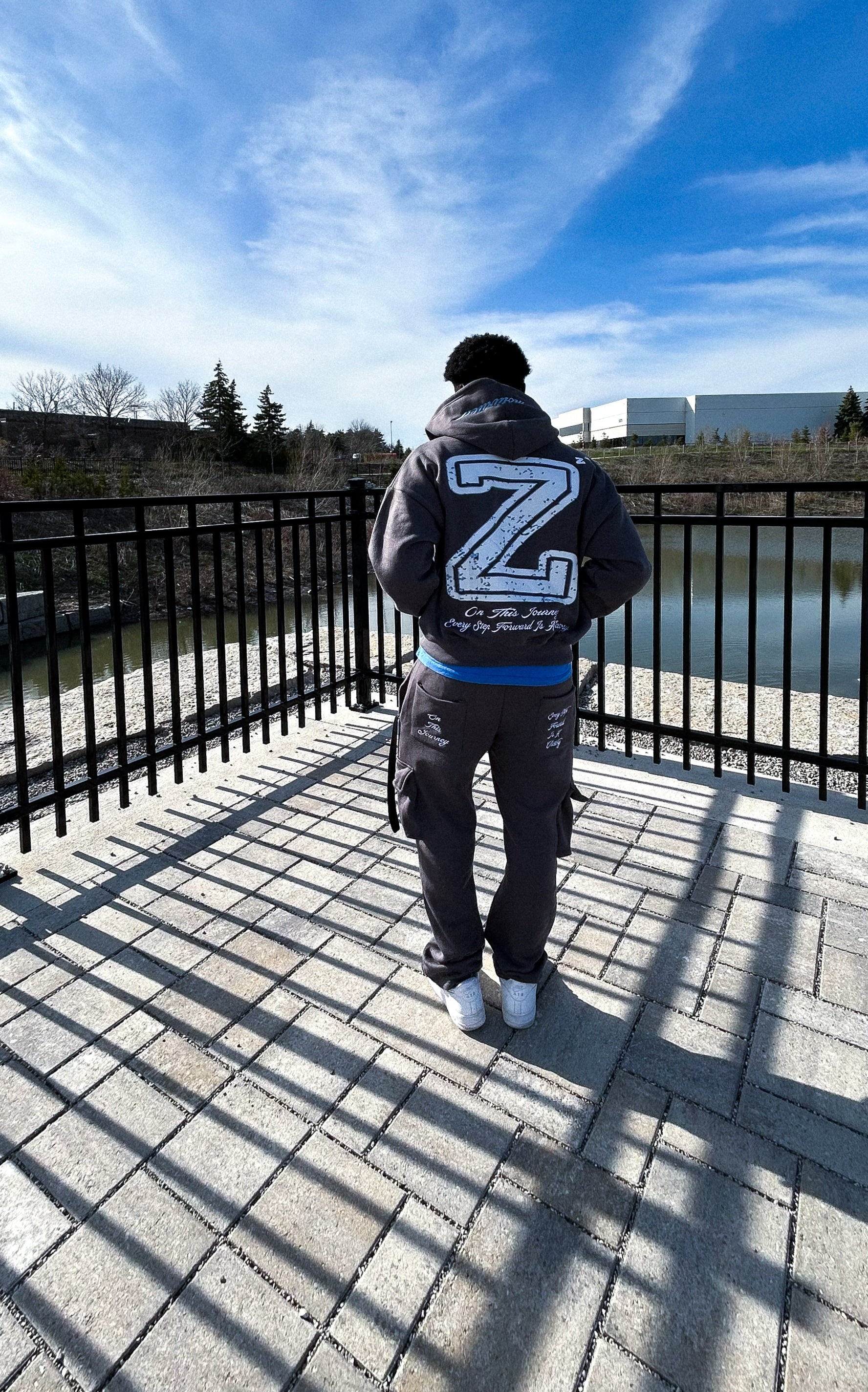 Model is wearing our “VICTORY” cargo pants and hoodie in the charcoal grey colorway